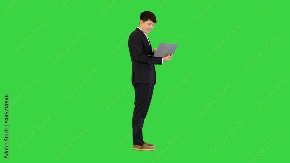 Asian man working with laptop on a Green Screen, Chroma Key. Asian man working with laptop on a Green Screen, Chroma Key.