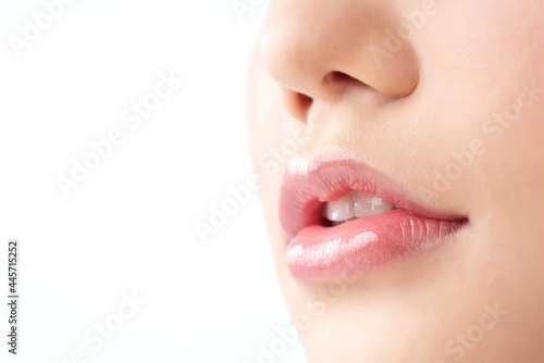 Close-up Beautiful lips. Part of face  young asian woman close up. Sexy plump lips Nude lipstick  on white background