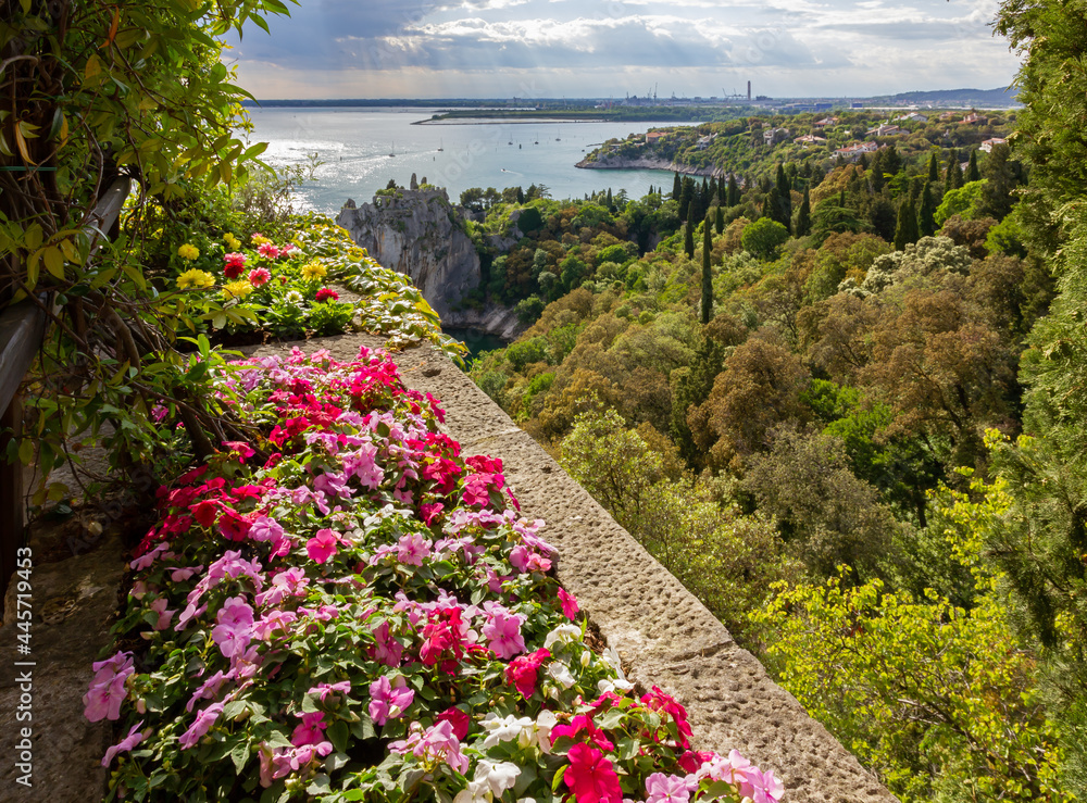 Naklejka premium View from a flower decorated terrace of the castle of Duino on the coast toward Monfalcone