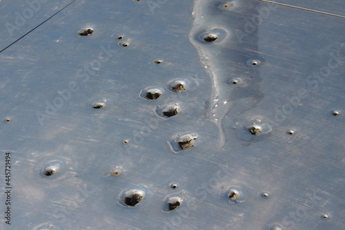 Metal plate with traces of bullets