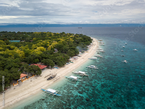 Scenic Aerial Drone Panorama Picture of A White Sand Beach with Bangka Boats in Balicasag Island in Panglao, Bohol, Philippines photo