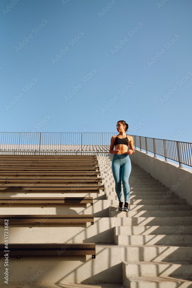 Young fitness woman exercising and stretching outdoors in the morning. Fit healthy athlete is doing workout on the street. Sport, Active life. Young fitness woman exercising and stretching outdoors in the morning. Fit healthy athlete is doing workout on the street. Sport, Active life.