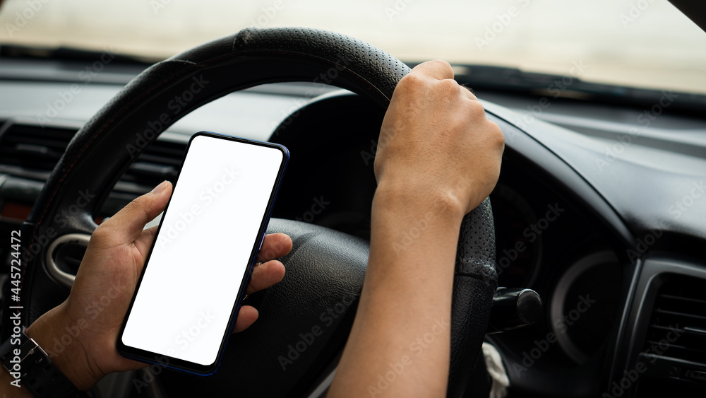 Young man hand holding a cell phone with a white screen driving a gps routing concept.
