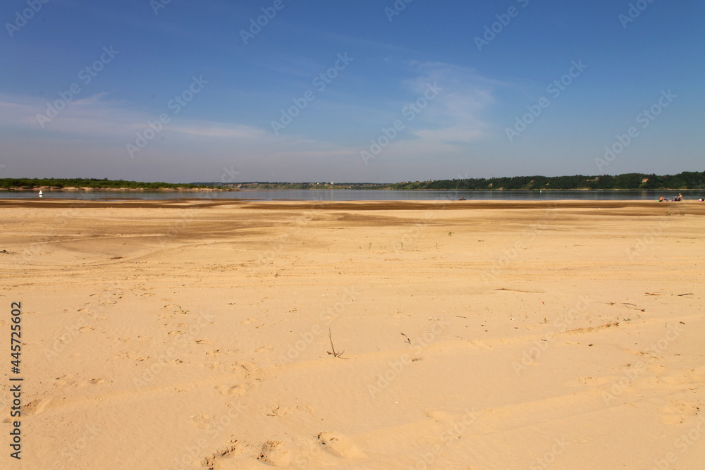 natural background clean sandy beach and sky with clouds