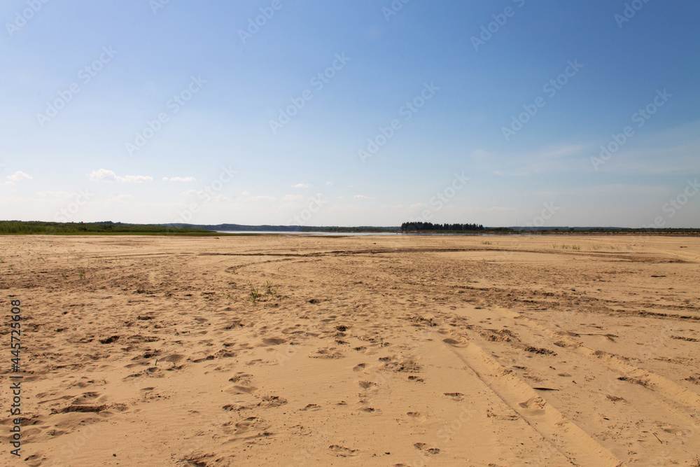 natural background clean sandy beach and sky with clouds