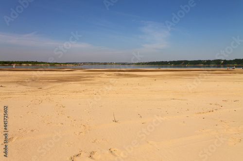 natural background clean sandy beach and sky with clouds