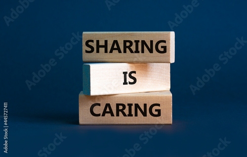 Sharing is caring symbol. Wooden blocks with words 'Sharing is caring' on beautiful grey background. Business, sharing is caring concept. Copy space.