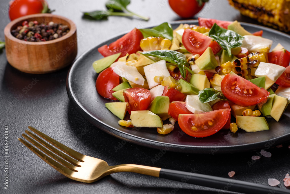 Delicious fresh salad with tomatoes, avocado, cheese and grilled corn with olive oil Delicious fresh salad with tomatoes, avocado, cheese and grilled corn with olive oil