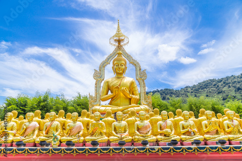 Row of disciple statues surrounding big buddha statue in public to the general public worship worship  Thailand.