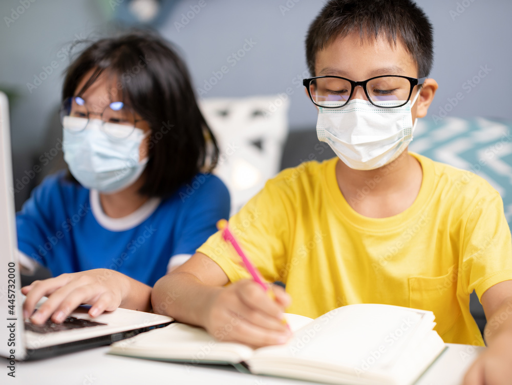 students wearing a face mask study in the room. students wearing a face mask study in the room.