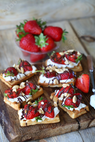 Waffles with cream cheese and strawberries. Healthy breakfast or dessert.