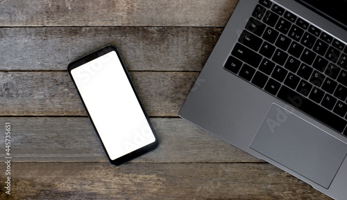 Smart phone with empty screen on wooden desk. Top view Communicator Technology On Wood Table Top View