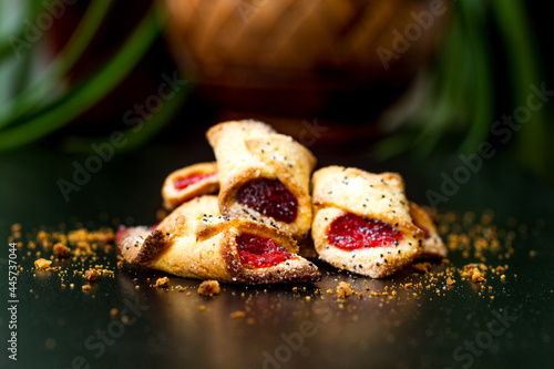 Cookies with raspberry jam for tea on a dark background.