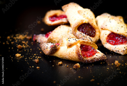 Cookies with raspberry jam for tea on a dark background.