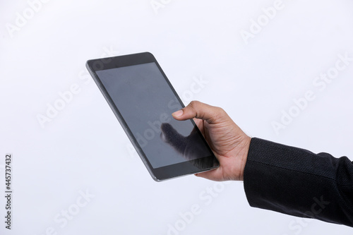 Young indian businessman using tablet over white background.