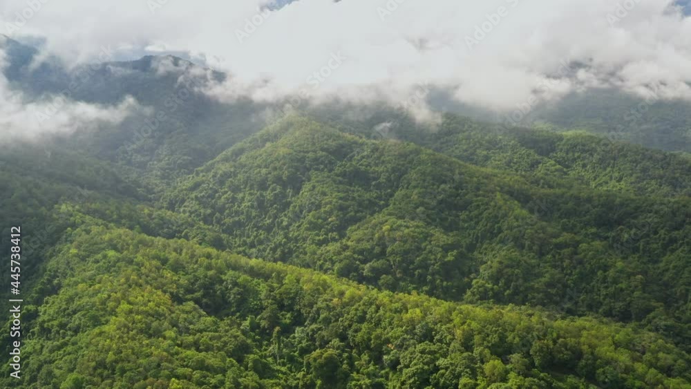 Aerial view flying above lush green tropical rain forest mountain with rain cloud cover during the rainy season on the Doi Phuka Mountain reserve national park. In, the northern Thailand Aerial view flying above lush green tropical rain forest mountain with rain cloud cover during the rainy season on the Doi Phuka Mountain reserve national park. In, the northern Thailand
