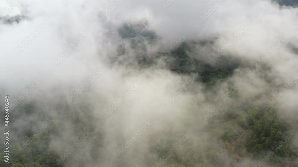 Aerial view flying above lush green tropical rain forest mountain with rain cloud cover during the rainy season on the Doi Phuka Mountain reserve national park. In, the northern Thailand Aerial view flying above lush green tropical rain forest mountain with rain cloud cover during the rainy season on the Doi Phuka Mountain reserve national park. In, the northern Thailand