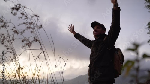 Portrait adventurous man with a backpack enjoying the mountain scenery photo