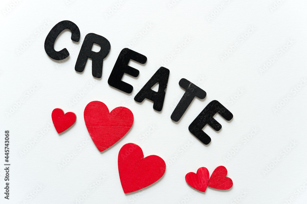 create spelled out in black chalk letters with hand painted red hearts on a white background