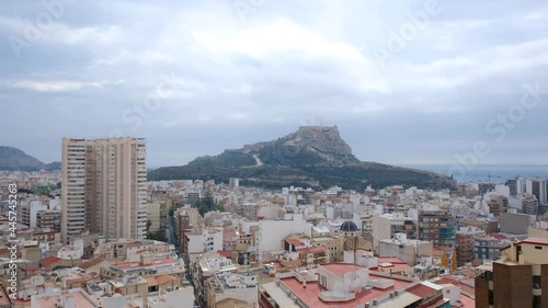 Time-lapse of light passing through clouds with city and castle in the background in Alicante Castillo Santa Bárbara