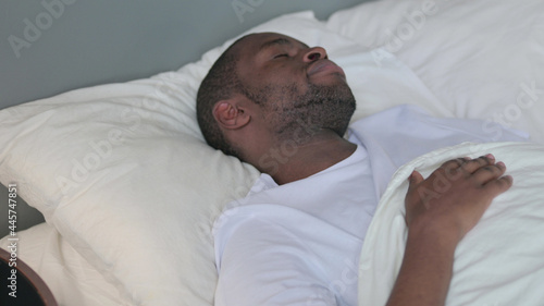 Young African Man Waking Up from Sleep in Bed 