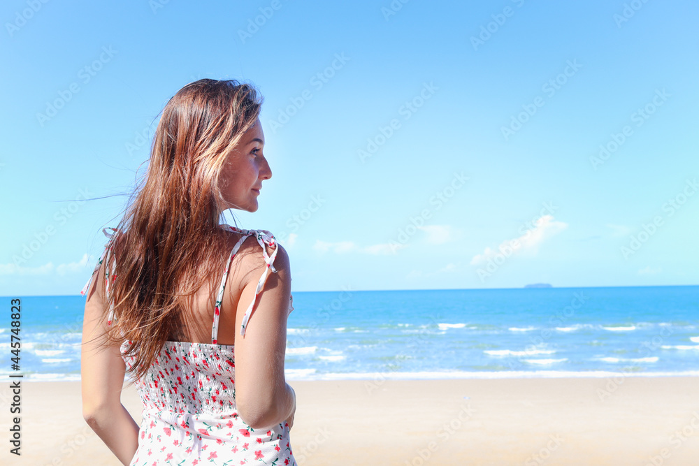 Portrait of smiling young beautiful woman with blond long hair standing on tropical blue sea summer beach, relaxing vacation summer concept. Portrait of smiling young beautiful woman with blond long hair standing on tropical blue sea summer beach, relaxing vacation summer concept.