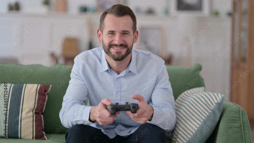 Excited Young Man Playing and Winning Video Game Excited Young Man Playing and Winning Video Game