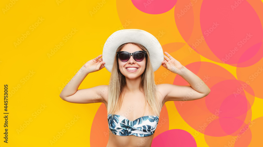 A young pretty caucasian smiling blonde woman in a swimsuit top, white hat, sunglasses is happy about the upcoming vacation isolated on a color yellow pink background. Summer tropics travel concept A young pretty caucasian smiling blonde woman in a swimsuit top, white hat, sunglasses is happy about the upcoming vacation isolated on a color yellow pink background. Summer tropics travel concept