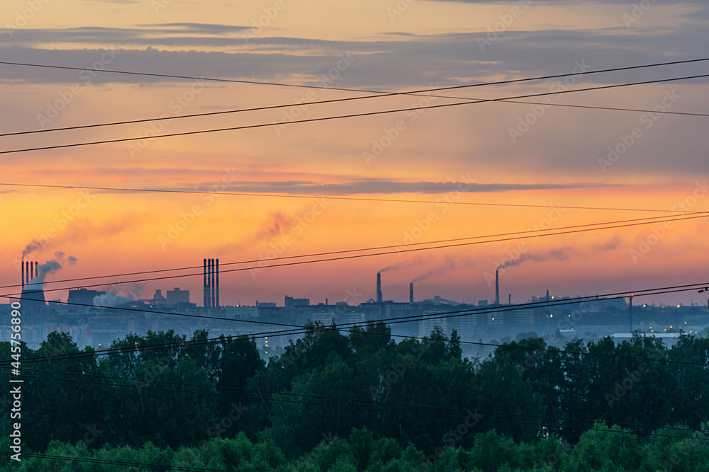 Smoking chimneys at dawn. Forest, industrial landscape and wires. The border of nature and civilization. Smoking chimneys at dawn. Forest, industrial landscape and wires. The border of nature and civilization.