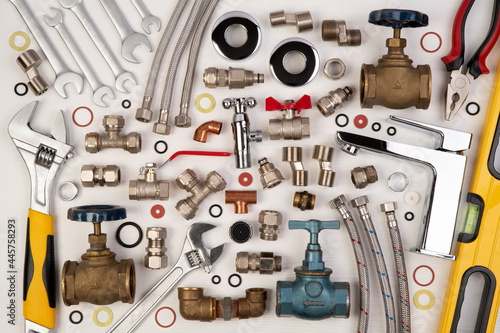 Cuadro en lienzo Plumber tools and spare parts on white wooden background, top view, flat lay