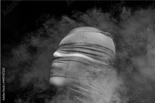 Human wear mask on dark background.