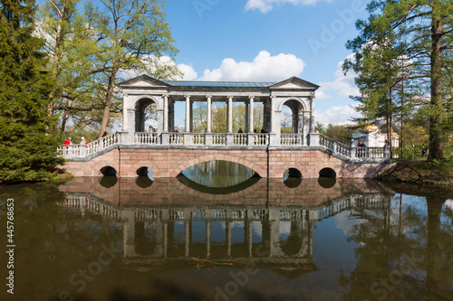 arched bridge on the pond in the park photo