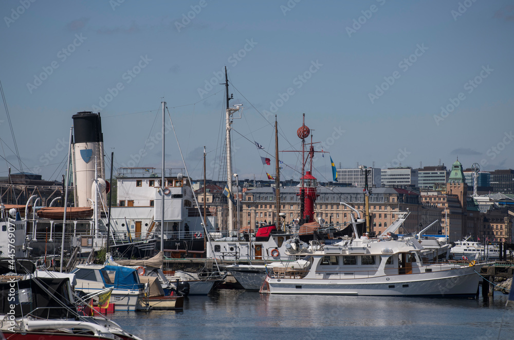Piers with mixed types of boats as day cruisers, ice breaker and lighthouse ship at the island Djurgården in Stockholm