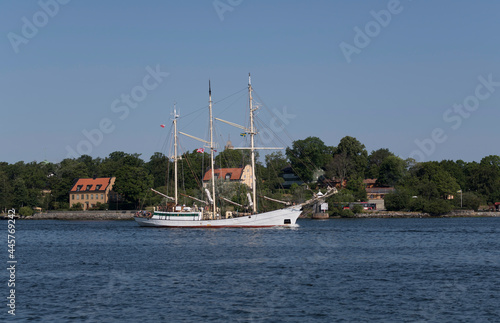 Old sailing boat with three masts passing the point Blockhusudden on the way to the Stockholm archipelago photo