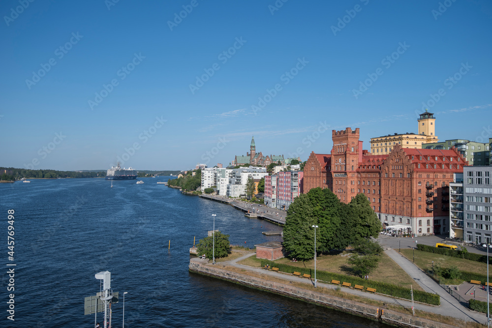 Obraz premium Large blue cruise ship in the Stockholm on it its way through the archipelago passing the water front of the district Nacka