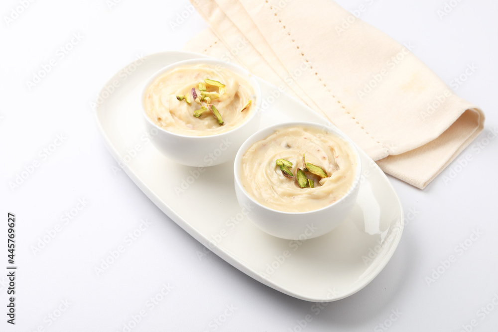 Shrikhand is an Indian sweet dish made of strained curd,garnished with