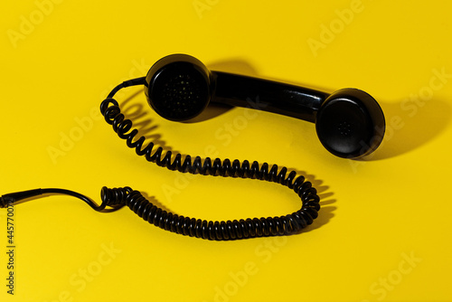 Telephone Headset. Old phone. The concept of communication. Isolated on a yellow background. 