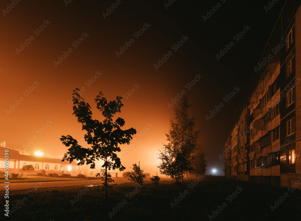 old residential apartment buildings in a foggy night. old residential apartment buildings in a foggy night.