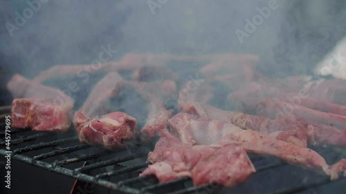 Juicy meat, ribs, fried, smoked, grilled. Lots of smoke. Close-up, Slow motion 240 fps.