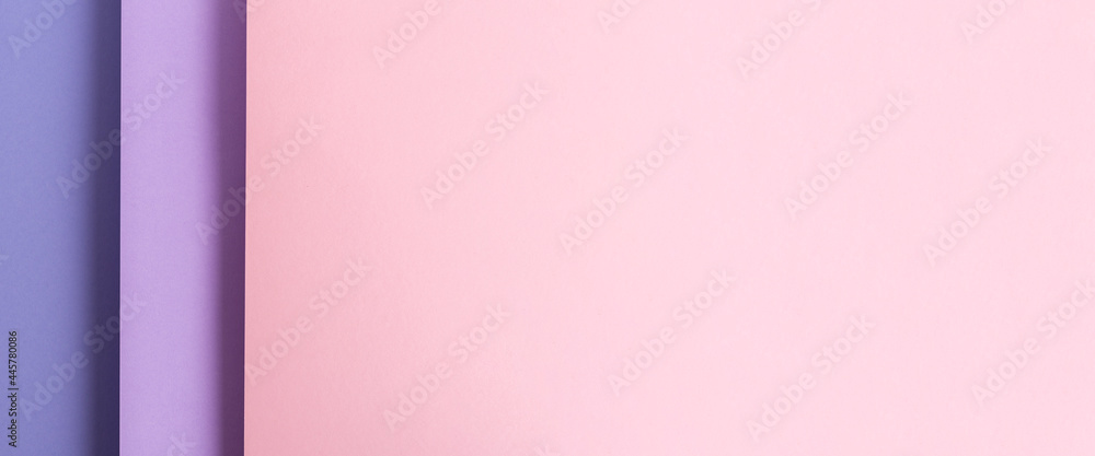 Design from folded paper pink lilac material backdrop. Top view, flat lay. Banner