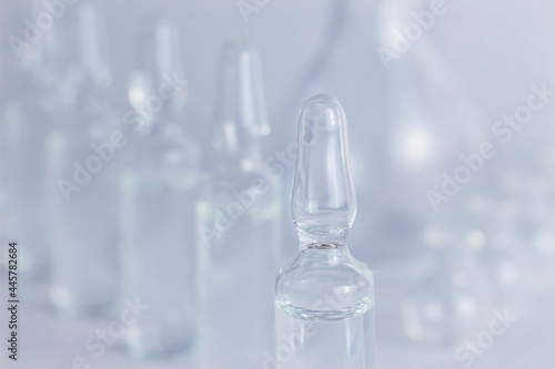 Glass transparent medical ampoules with liquid vaccine for injection in research laboratory