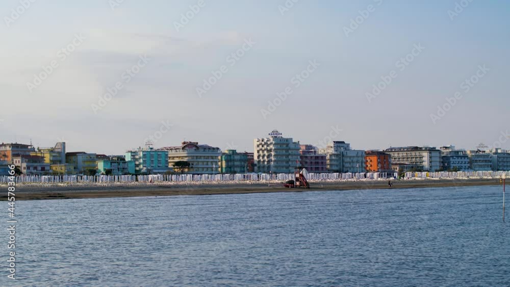 The coastline of an empty beach in Italy during beautiful summer sunset. No tourists at the beach due to travel restrictions during the Covid-19, Coronavirus pandemic. Caorle, Veneto. 4K. The coastline of an empty beach in Italy during beautiful summer sunset. No tourists at the beach due to travel restrictions during the Covid-19, Coronavirus pandemic. Caorle, Veneto. 4K.