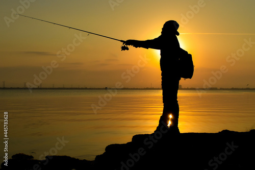 silhouette of fisherman in sunrise
