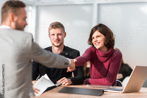 HR Manager shaking hands with young job seeker