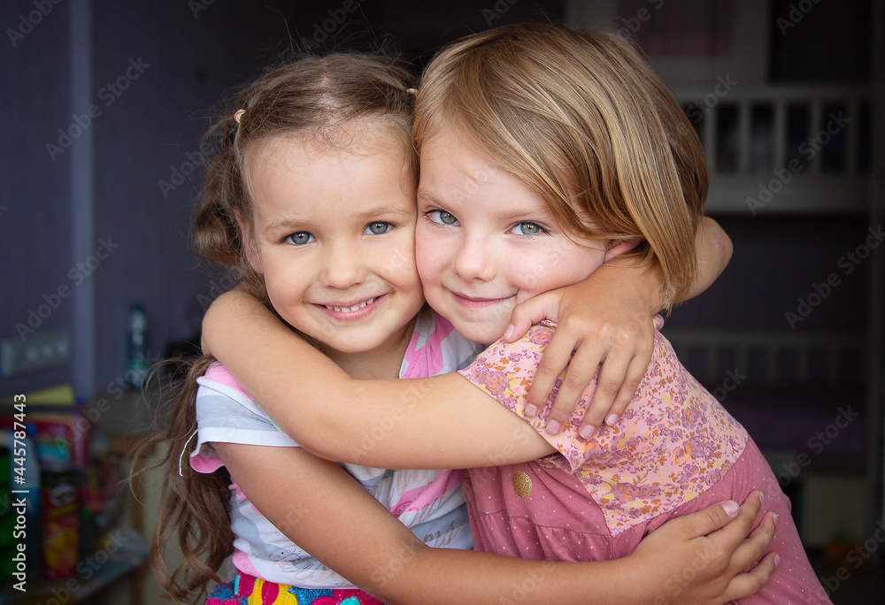 Two happy girls laugh, children hug, kids rejoice, childhood, two sisters.
Two happy girls laugh, children hug, kids rejoice, childhood, two sisters.