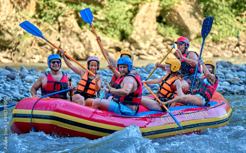 rafting on a large boat on a mountain river photo