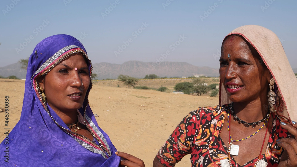 Two young Indian females in traditional clothes in an outdoor place ...