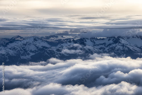 Aerial View from Airplane of Canadian Mountain Landscape in Spring time. Colorful Sunset Sky. Garibaldi Peak near Squamish and Vancouver, British Columbia, Canada. Authentic Image