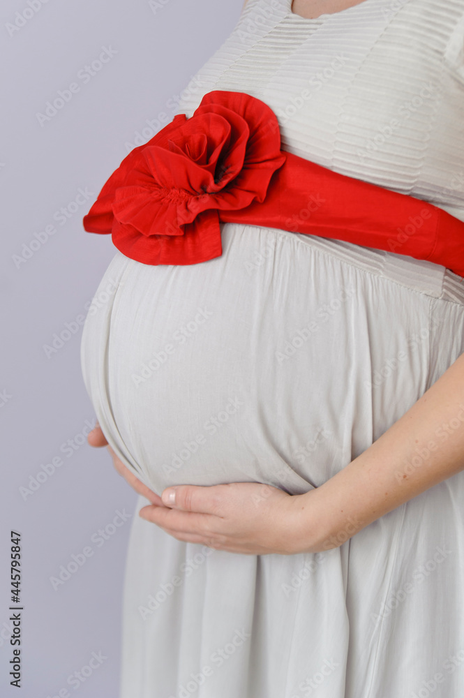 Happy Couple Waiting a Baby. Parents Hands on the Belly of the Pregnant Mother.