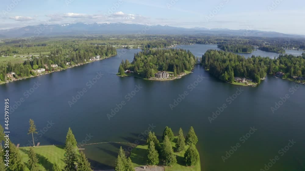 Beautiful View of a String of Islands on a Lake with a Snow-capped Mountain on the Horizon Beautiful View of a String of Islands on a Lake with a Snow-capped Mountain on the Horizon